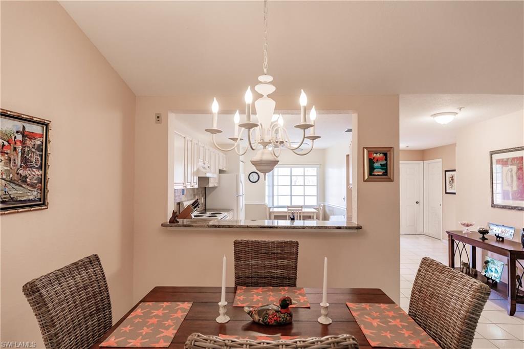 320 Gabriel Circle, Unit 3608 Naples, FL 34104 - Photo 9 of 32 a room with chandelier furniture and window