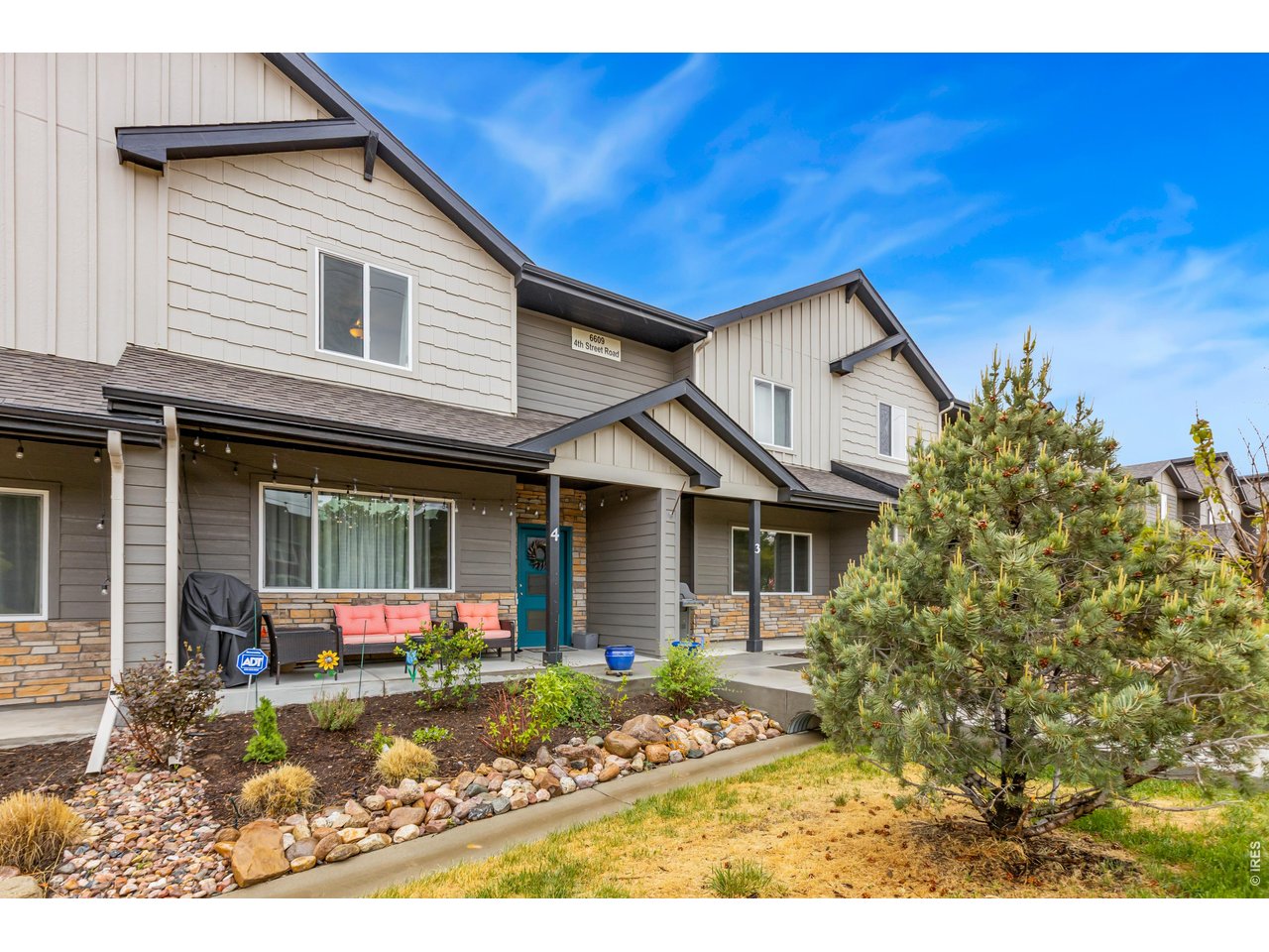 6609 4th St Road, Unit 4 Greeley, CO 80634 - Photo 2 of 41 a front view of a house with garden