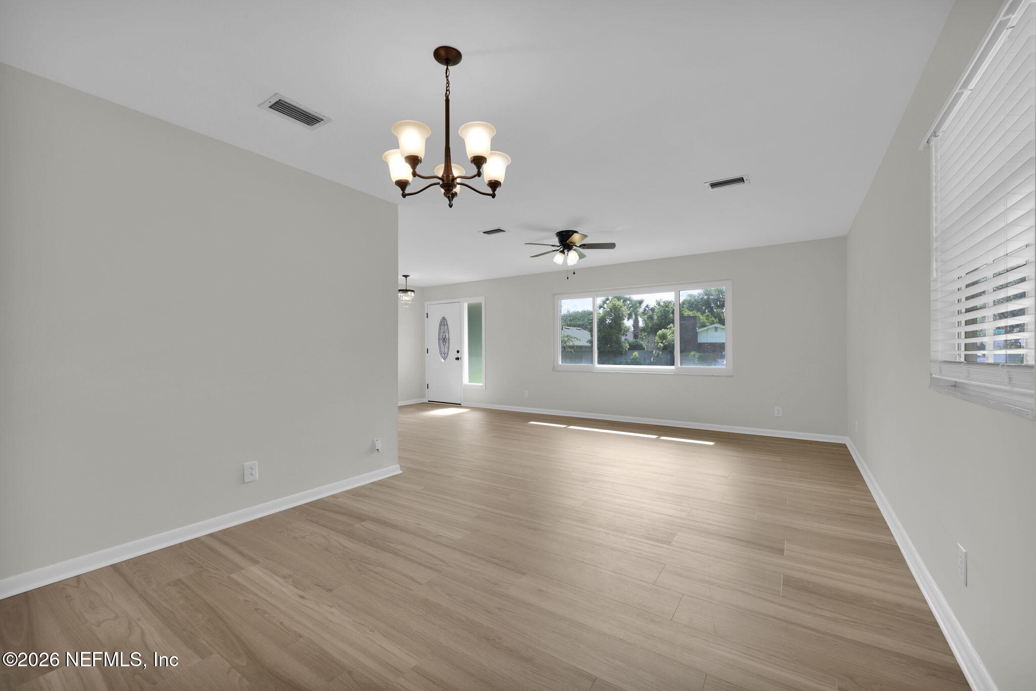 8544 Sanchez Road Jacksonville, FL 32217 - Photo 14 of 46 wooden floor in an empty room with a window