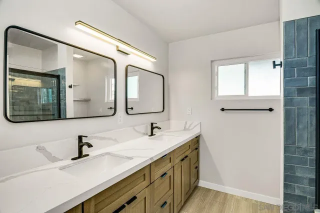 a bathroom with a double vanity sink mirror and