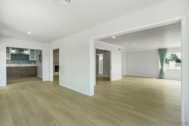 a view of an empty room with a kitchen