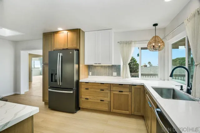 a kitchen with a refrigerator and a sink