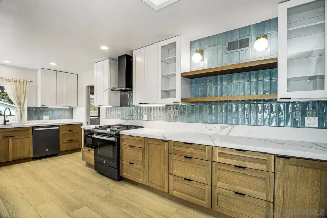 a kitchen with cabinets a sink and appliances