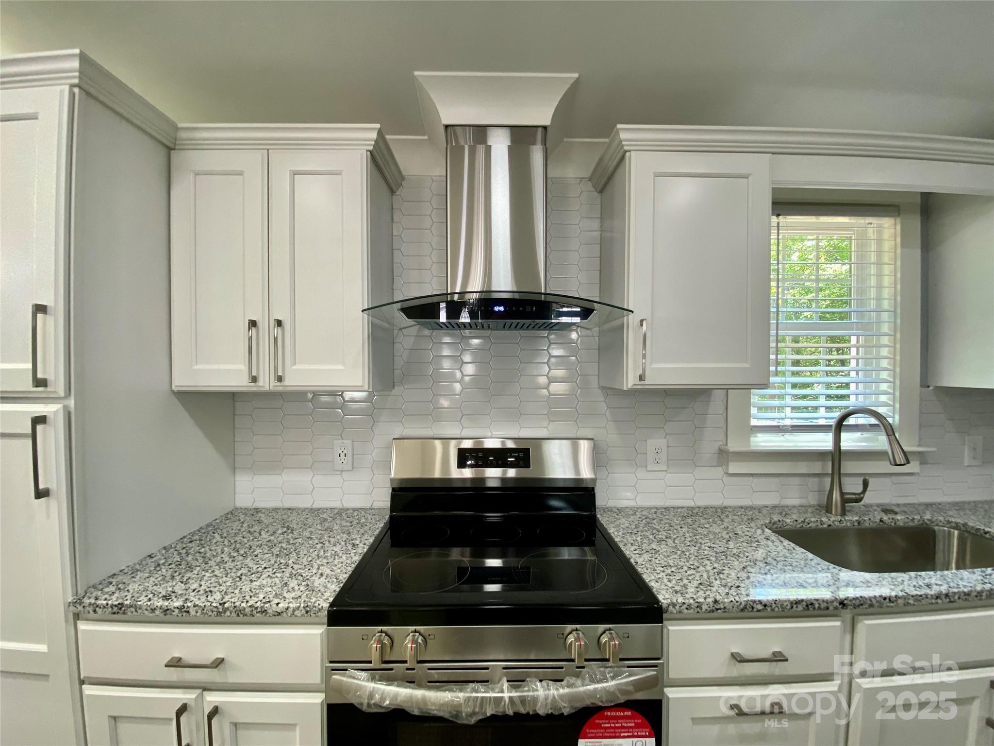 109 Bee Tree Lane Salisbury, NC 28144 - Photo 14 of 39 a kitchen with granite countertop a stove a sink and a white cabinets