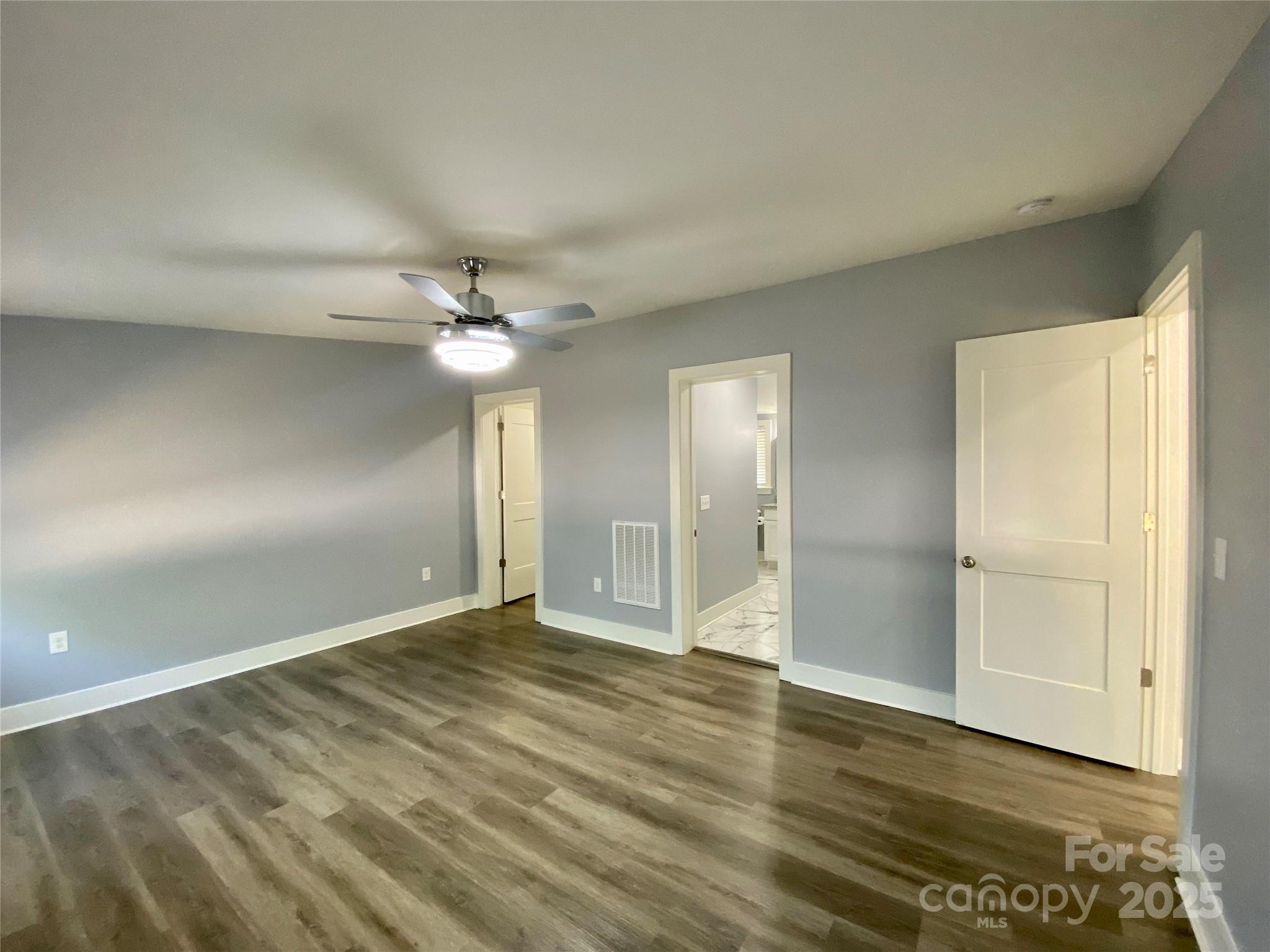 109 Bee Tree Lane Salisbury, NC 28144 - Photo 18 of 39 an empty room with wooden floor fan and windows