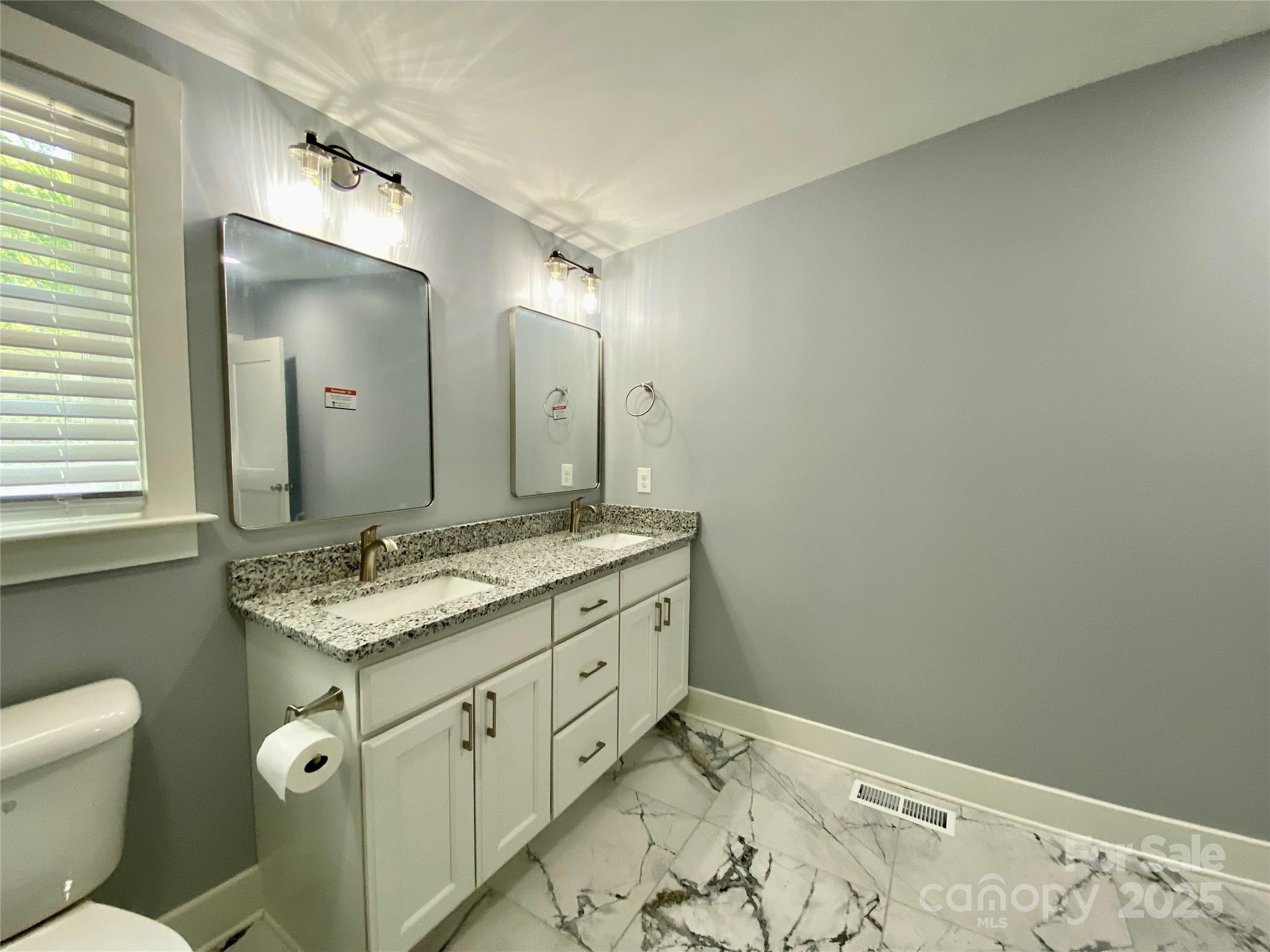 109 Bee Tree Lane Salisbury, NC 28144 - Photo 22 of 39 a bathroom with a granite countertop sink mirror vanity and toilet