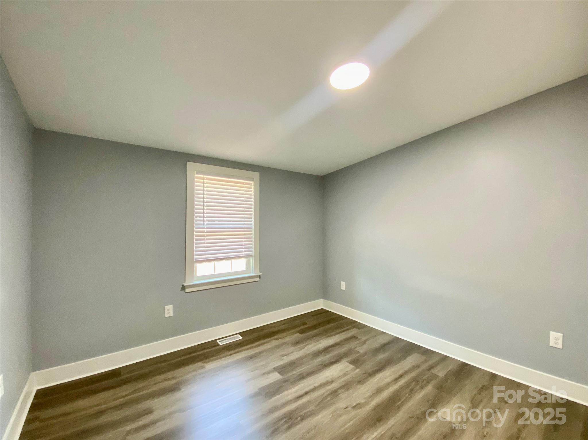 109 Bee Tree Lane Salisbury, NC 28144 - Photo 24 of 39 an empty room with wooden floor and windows