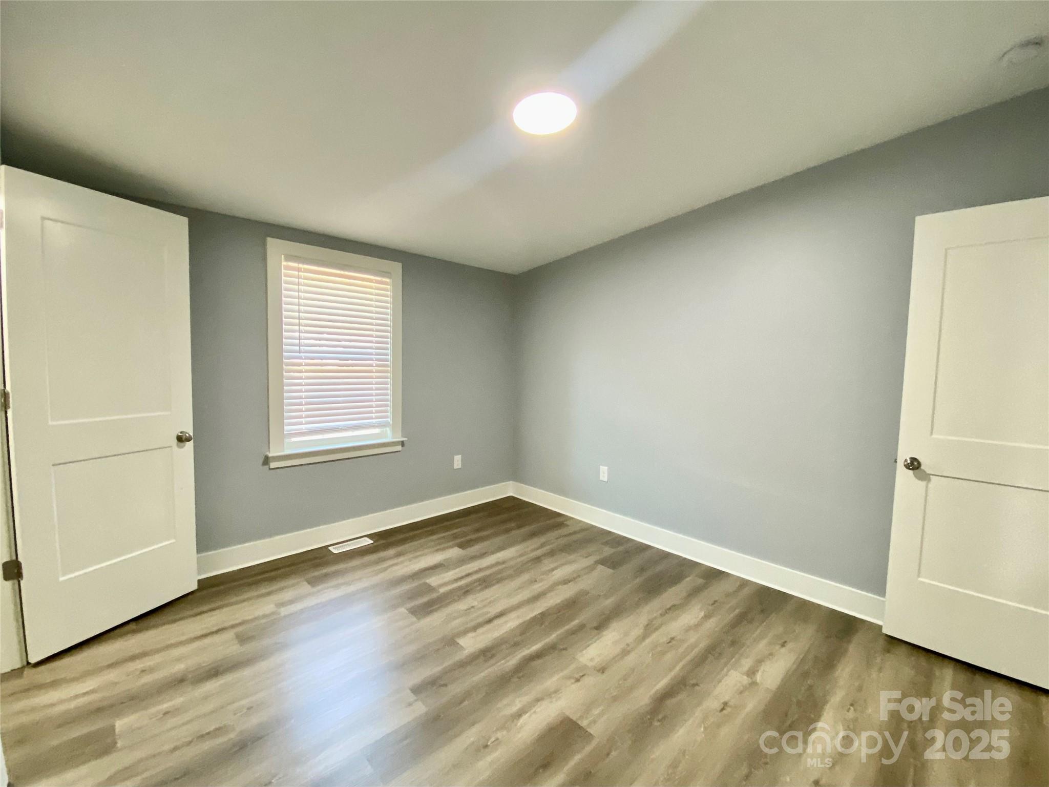 109 Bee Tree Lane Salisbury, NC 28144 - Photo 26 of 39 an empty room with wooden floor and windows