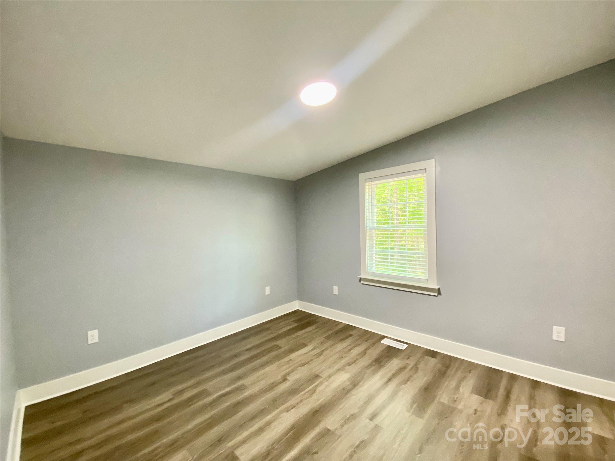 109 Bee Tree Lane Salisbury, NC 28144 - Photo 29 of 39 a view of an empty room with wooden floor and a window