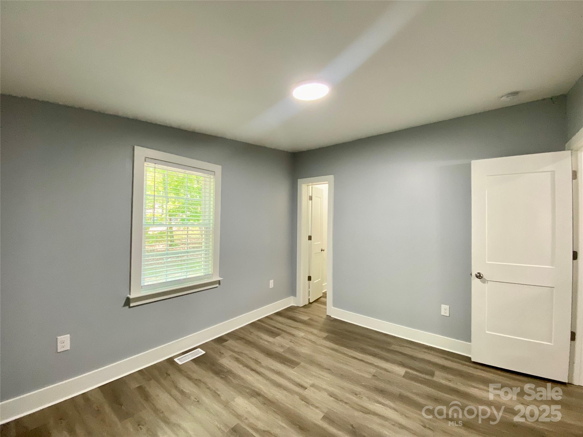109 Bee Tree Lane Salisbury, NC 28144 - Photo 30 of 39 an empty room with wooden floor and a window