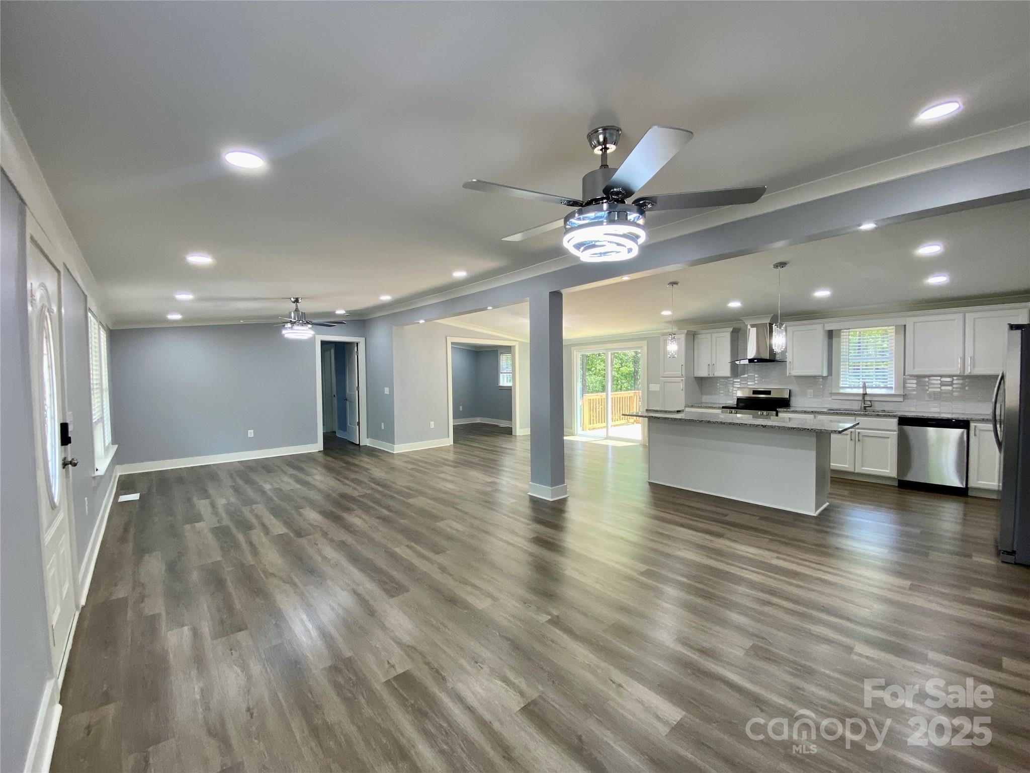 109 Bee Tree Lane Salisbury, NC 28144 - Photo 10 of 39 a view of an empty room and kitchen with granite countertop a stove top oven