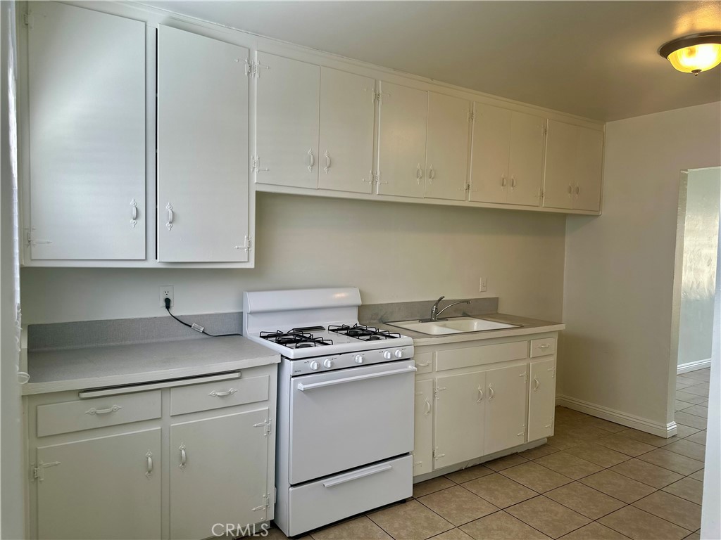 5147 Canoga Street, Unit A Montclair, CA 91763 - Photo 4 of 10 a kitchen with white cabinets appliances and sink
