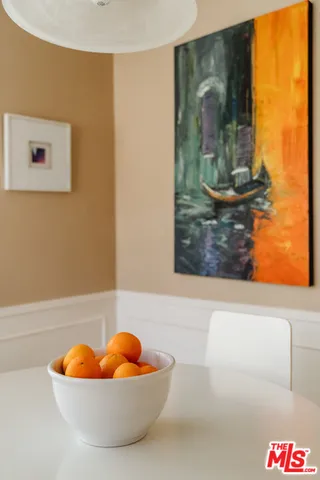 a large kitchen with a sink and refrigerator