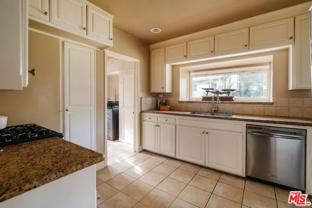 a kitchen with a stove top oven and sink
