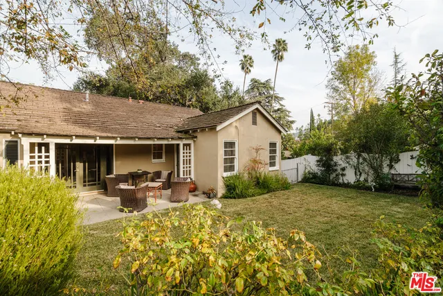 a view of a house with sitting area and garden
