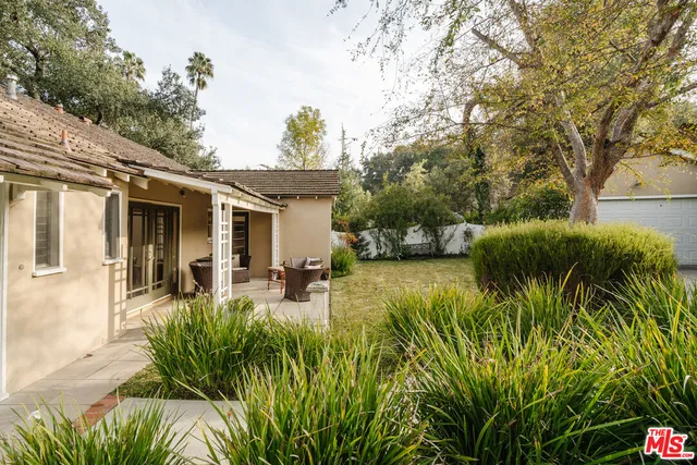 an aerial view of a house with a yard and lake view
