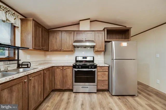 a kitchen with a stove refrigerator and a sink