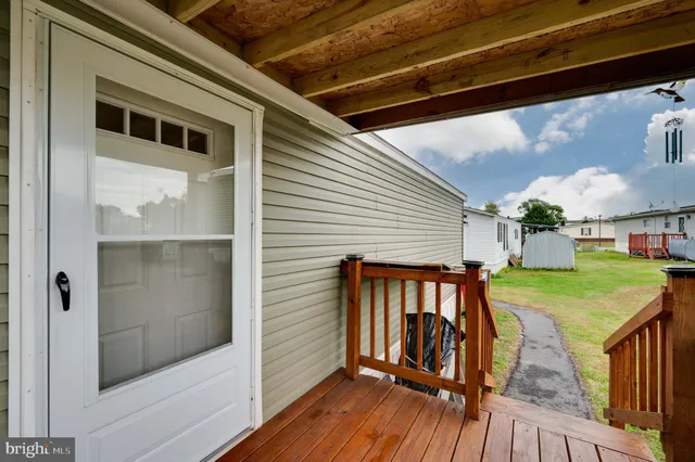 a view of a balcony with two chairs and a barbeque