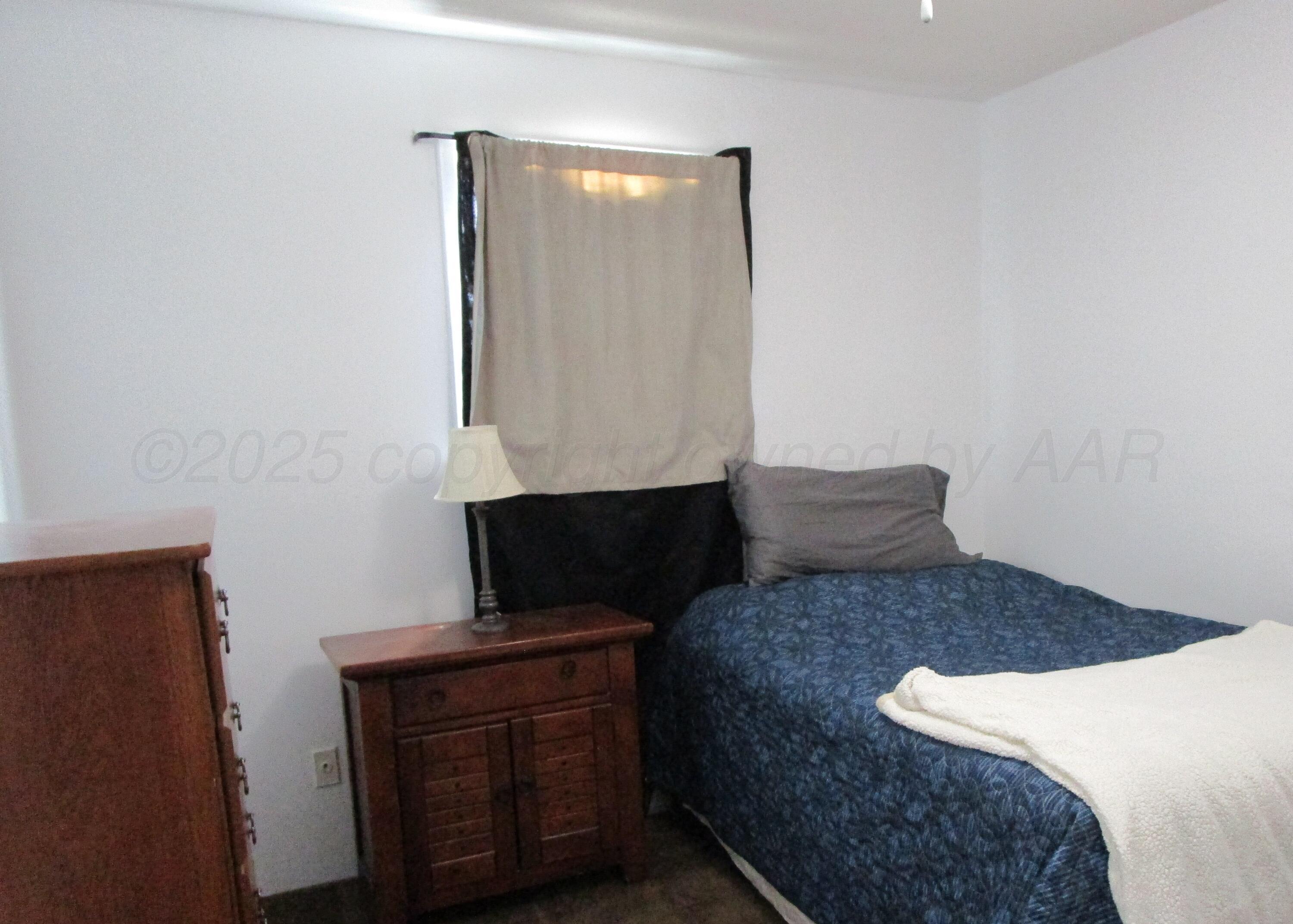 200 West 7th Street Borger, TX 79007 - Photo 5 of 7 a bedroom with a bed and a mirror