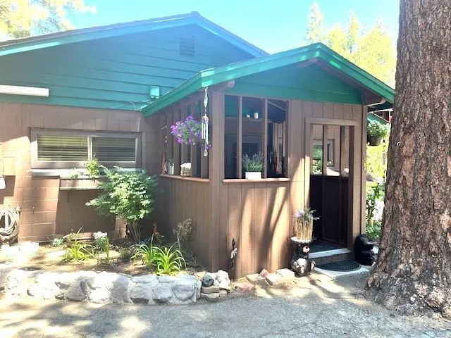a view of a house with a porch and garden