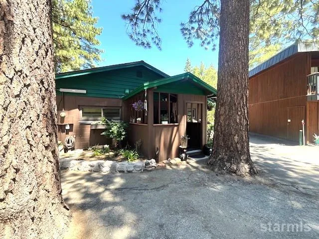 a view of a house with backyard and sitting area