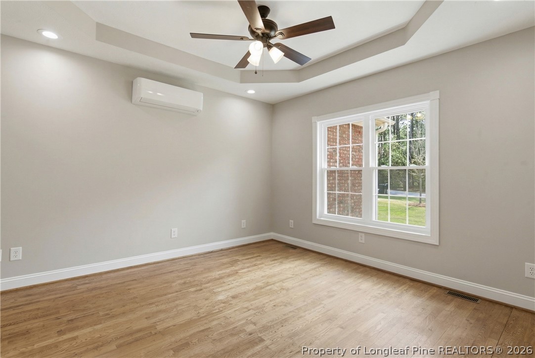 152 Ham Road Hope Mills, NC 28348 - Photo 11 of 50 an empty room with wooden floor ceiling fan and windows