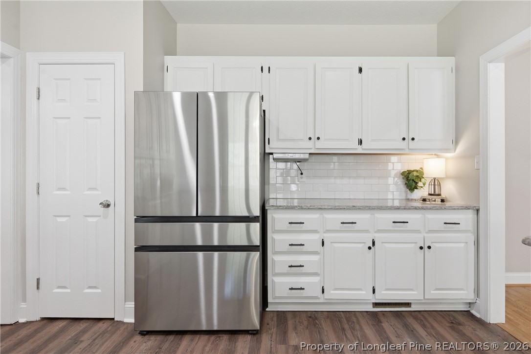152 Ham Road Hope Mills, NC 28348 - Photo 18 of 50 a kitchen with appliances cabinets and a wooden floor
