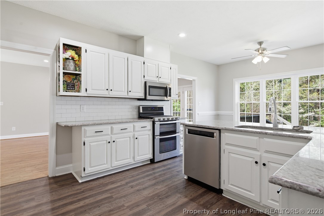152 Ham Road Hope Mills, NC 28348 - Photo 19 of 50 a kitchen with granite countertop cabinets stainless steel appliances and a window