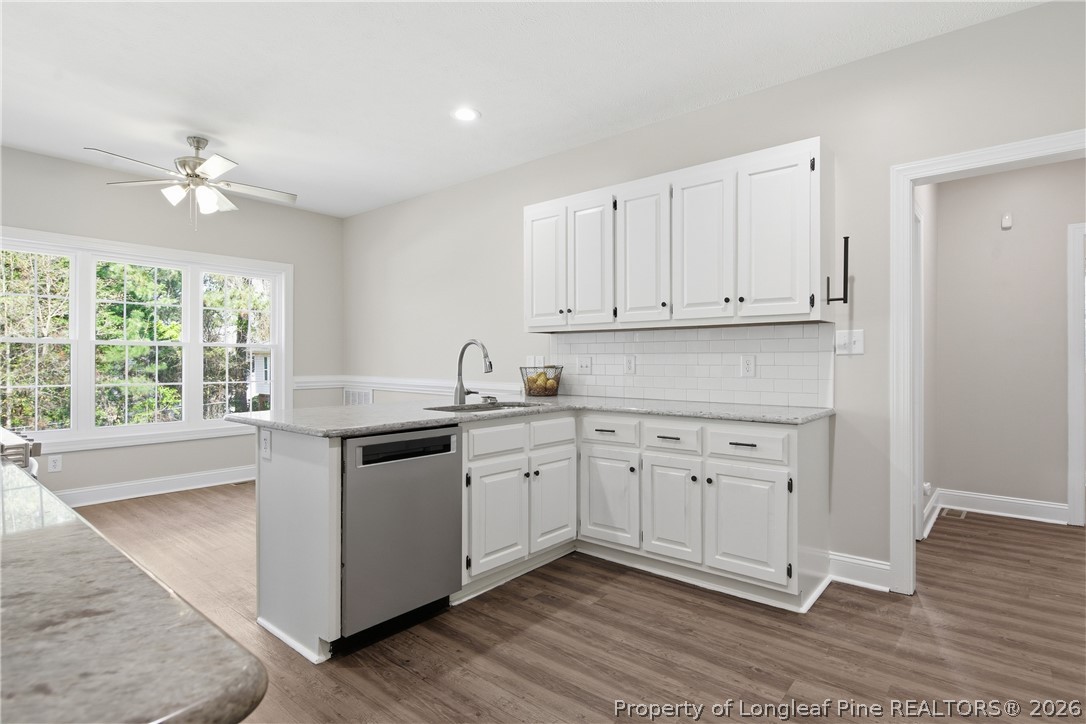 152 Ham Road Hope Mills, NC 28348 - Photo 20 of 50 a kitchen with granite countertop white cabinets white appliances with a sink and dishwasher
