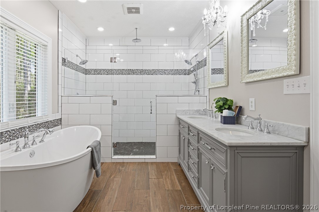 152 Ham Road Hope Mills, NC 28348 - Photo 31 of 50 a bathroom with a tub sink and mirror