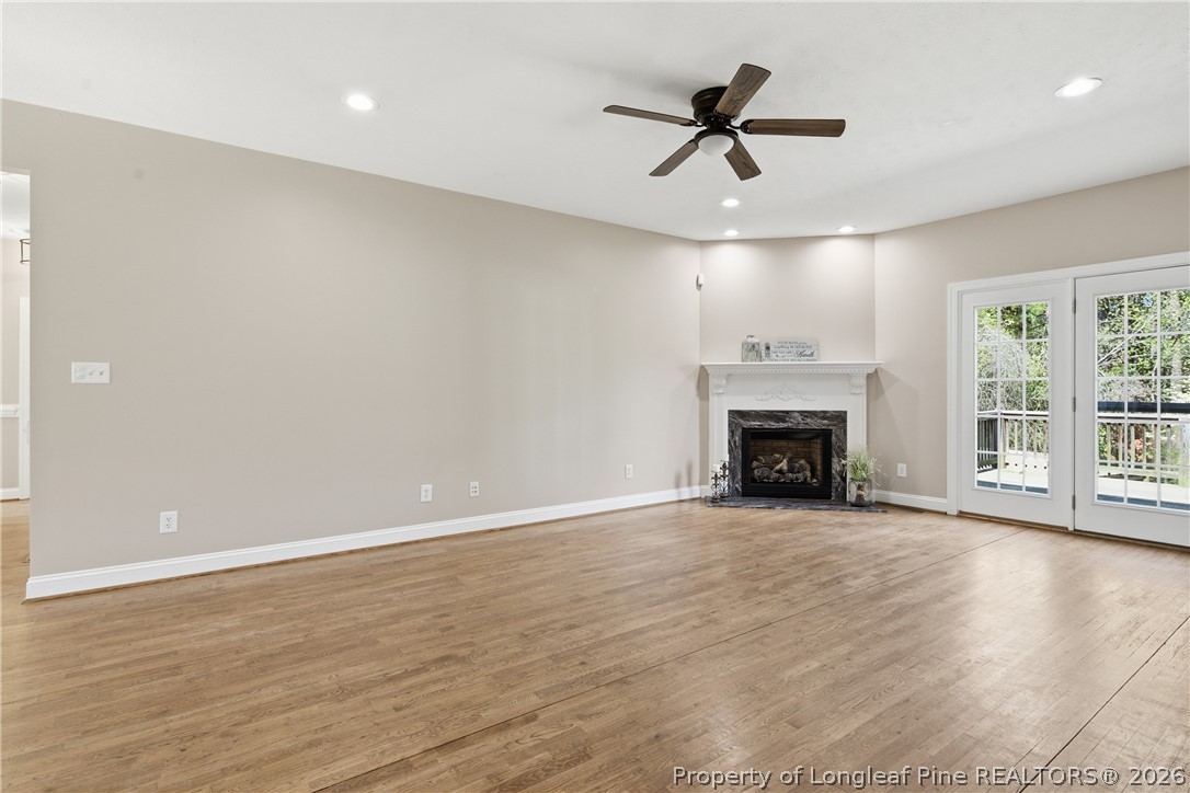 152 Ham Road Hope Mills, NC 28348 - Photo 7 of 50 wooden floor in an empty room with a fireplace and a window