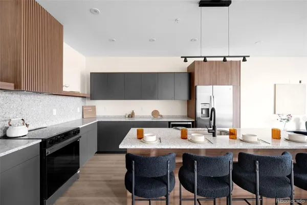 a kitchen with a sink cabinets and wooden floor