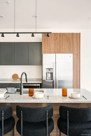 a kitchen with a sink a table and chairs