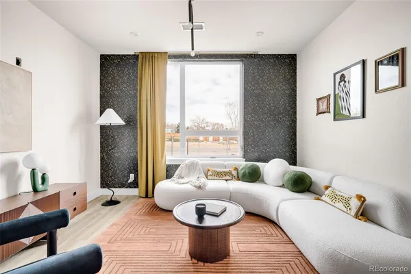 a living room with furniture and a large window