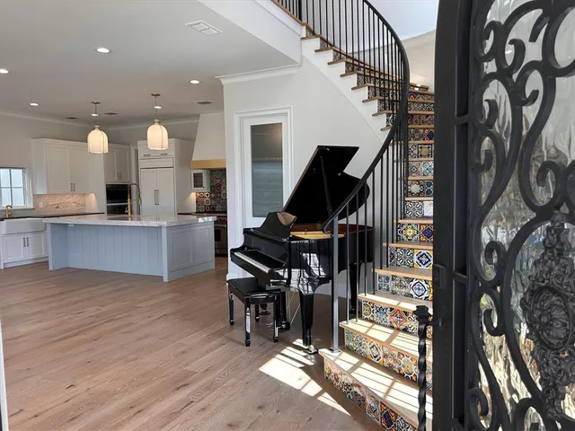 an empty room with wooden floor a fireplace and windows