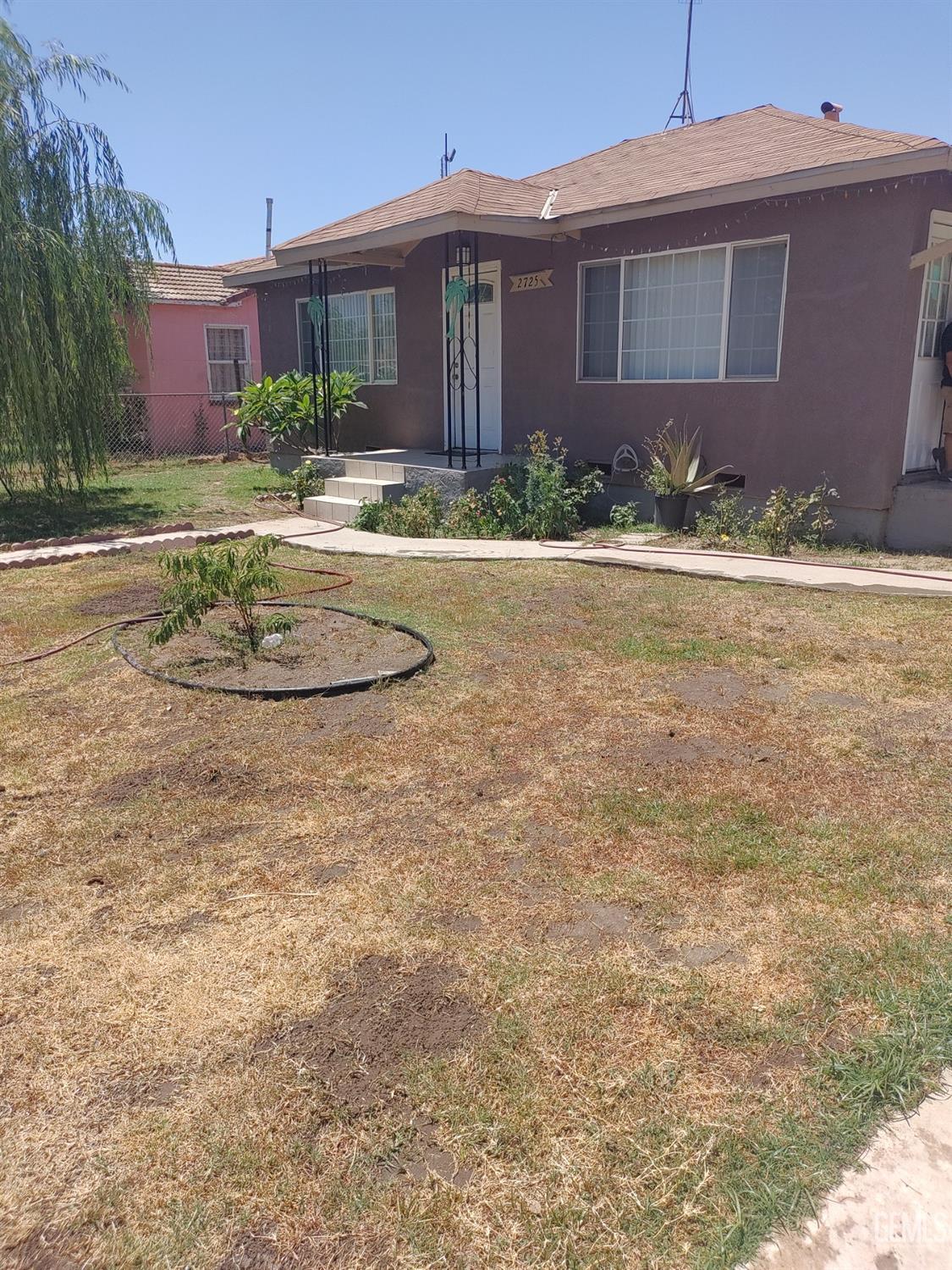 Undisclosed Address Bakersfield, CA 93307 - Photo 1 of 7 a front view of a house with a yard