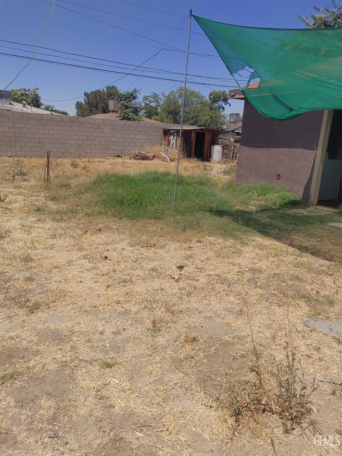 Undisclosed Address Bakersfield, CA 93307 - Photo 3 of 7 a backyard of a house with lots of green space