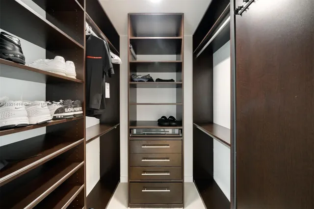 a view of walk in closet with empty racks