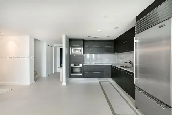a kitchen with stainless steel appliances a refrigerator and a stove