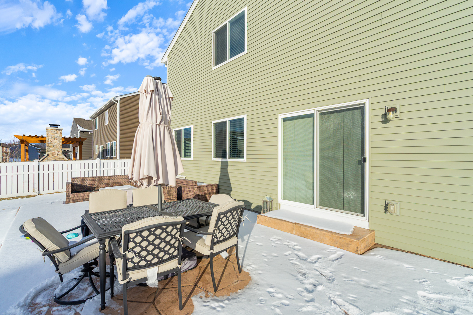 434 Stonebrook Drive Romeoville, IL 60446 - Photo 30 of 38 a view of a patio with a dining table and chairs with wooden floor