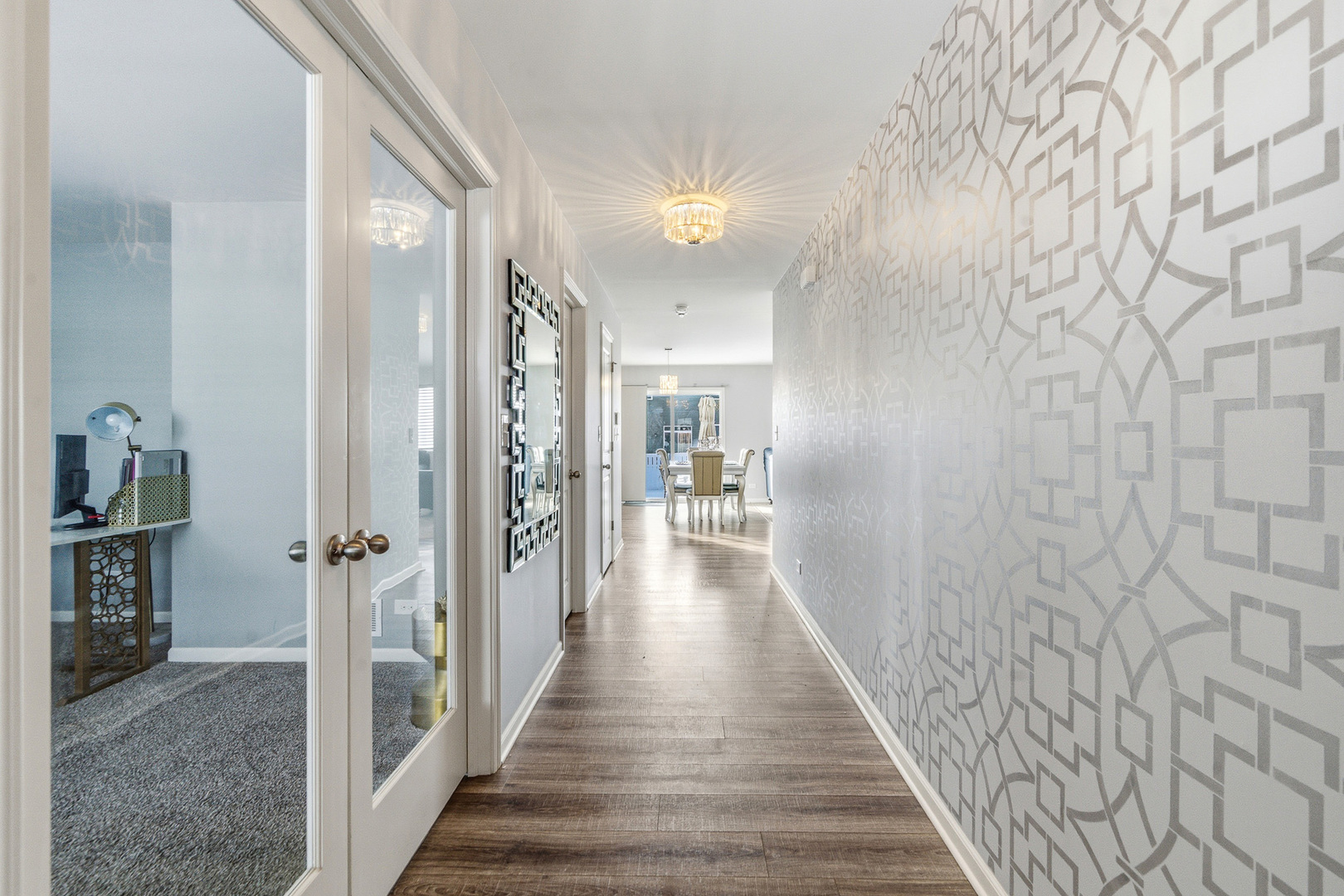 434 Stonebrook Drive Romeoville, IL 60446 - Photo 5 of 38 a view of a hallway with wooden floor and a living room
