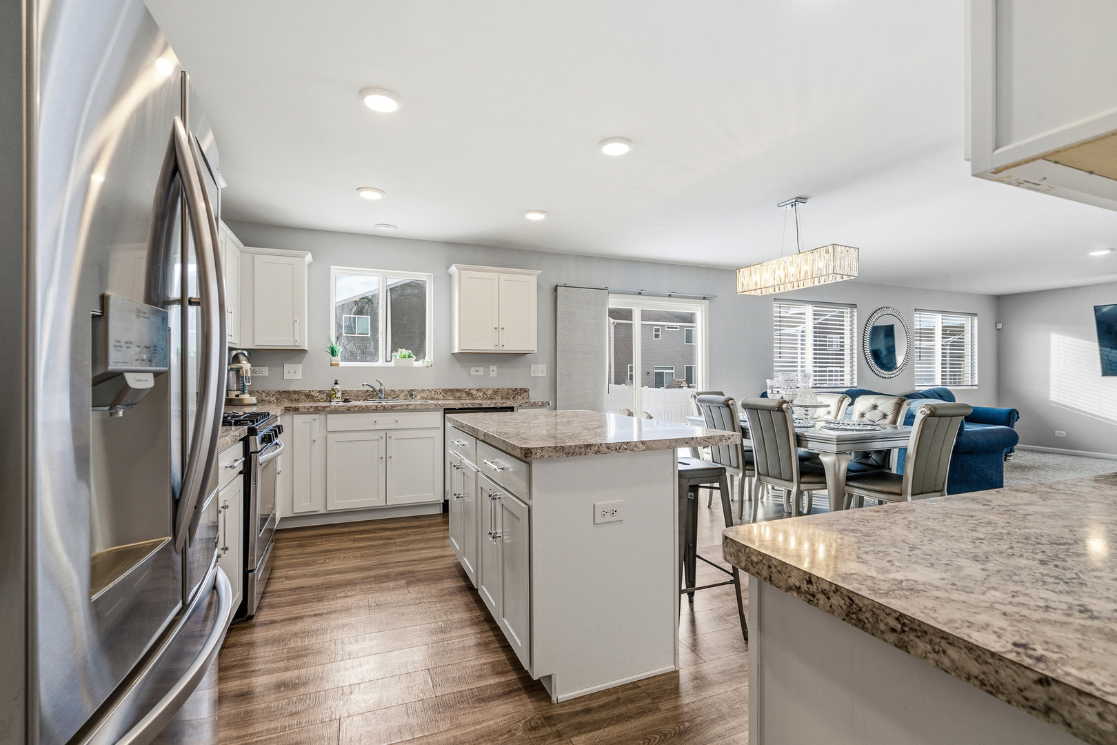 434 Stonebrook Drive Romeoville, IL 60446 - Photo 7 of 38 a kitchen with stainless steel appliances granite countertop a sink stove and refrigerator