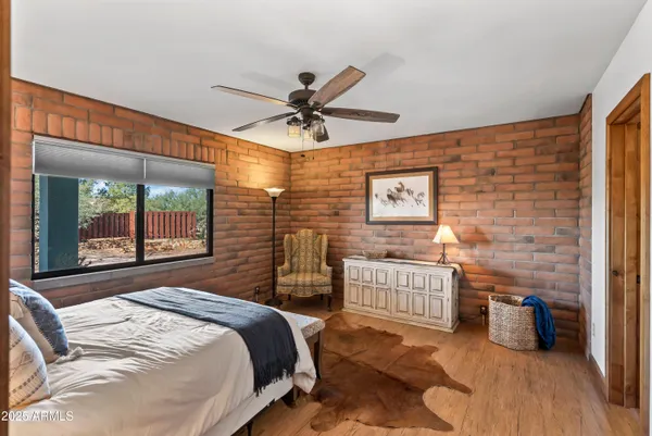 a bedroom with a bed and a ceiling fan