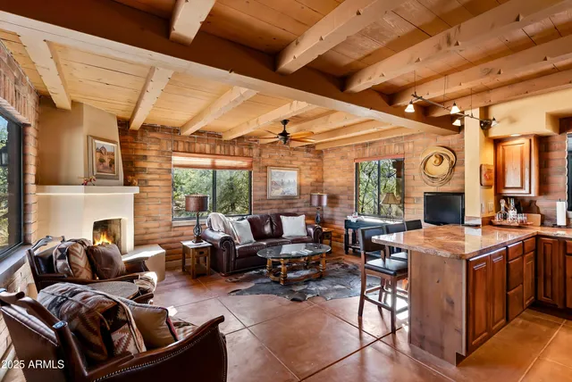 a living room with lots of furniture and kitchen view