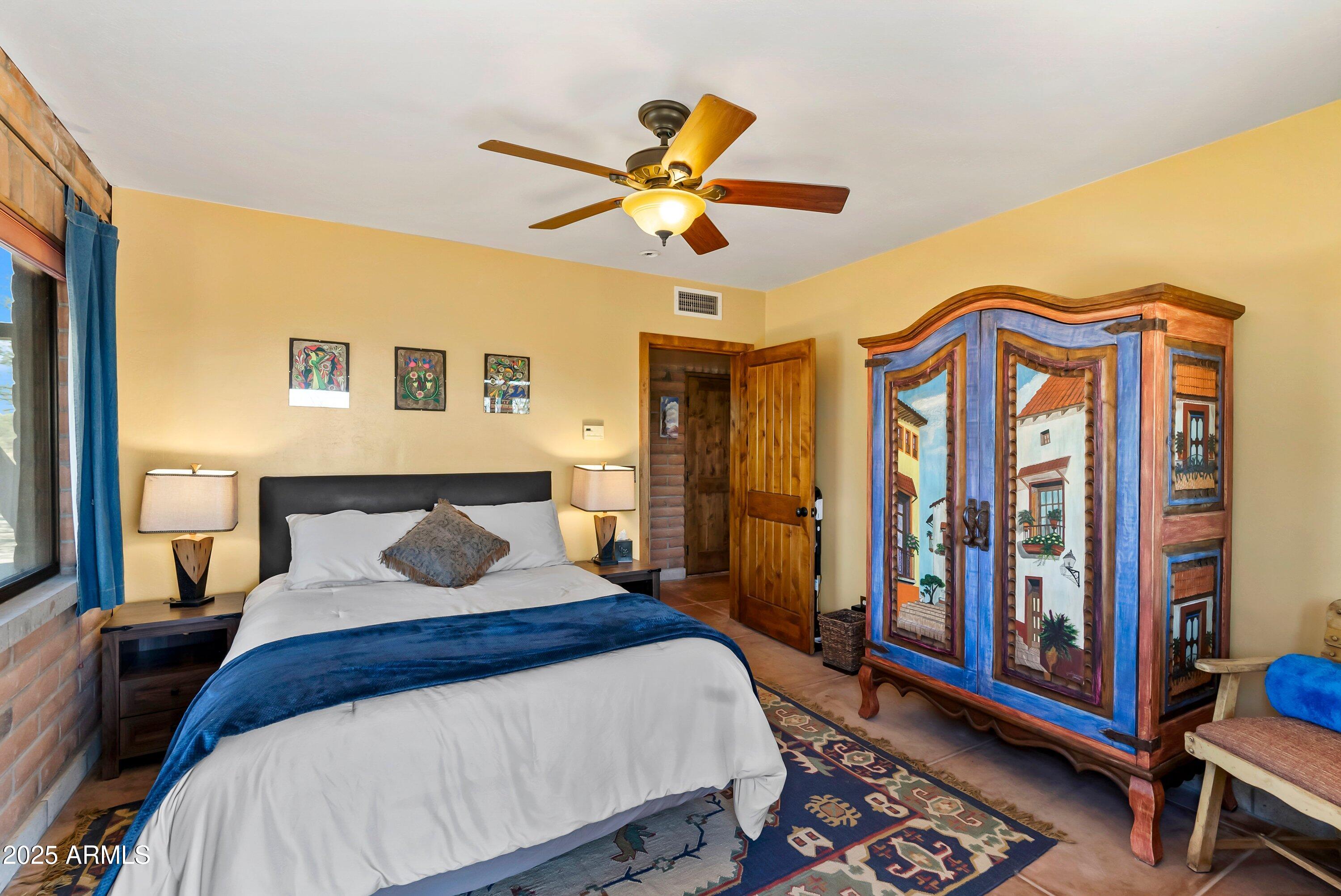 78 Camino Murphy Rio Rico, AZ 85648 - Photo 35 of 51 a bedroom with a bed and a chandelier