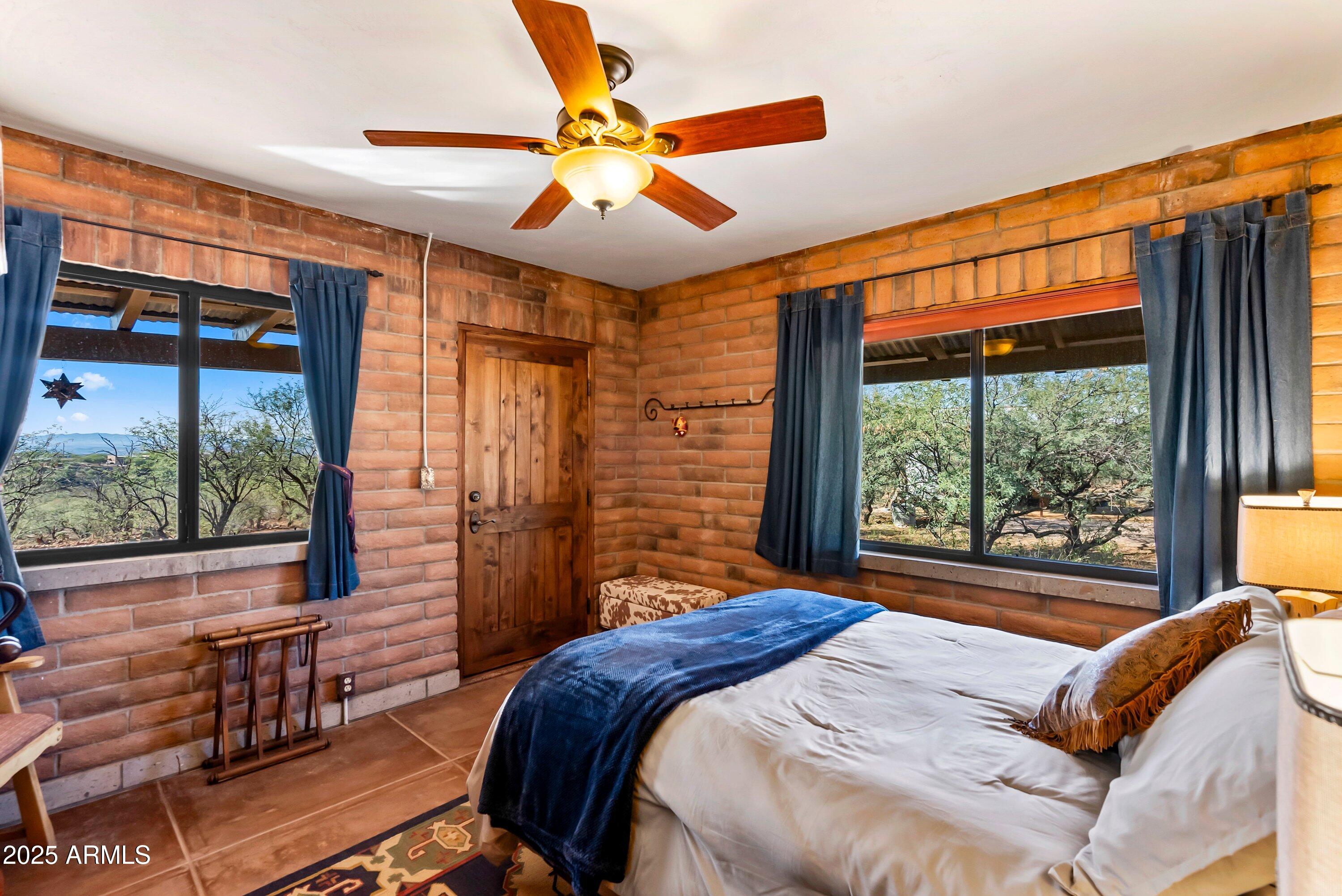 78 Camino Murphy Rio Rico, AZ 85648 - Photo 36 of 51 a bedroom with a large bed and a large window