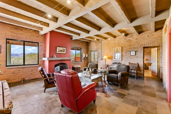 a living room with furniture a fireplace and dining table