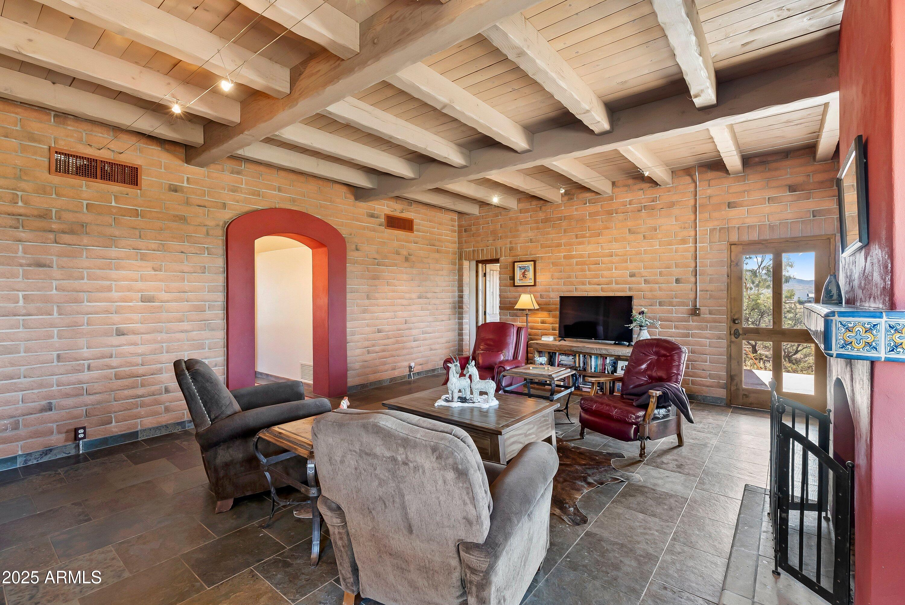 78 Camino Murphy Rio Rico, AZ 85648 - Photo 5 of 51 a living room with furniture a flat screen tv and a fireplace