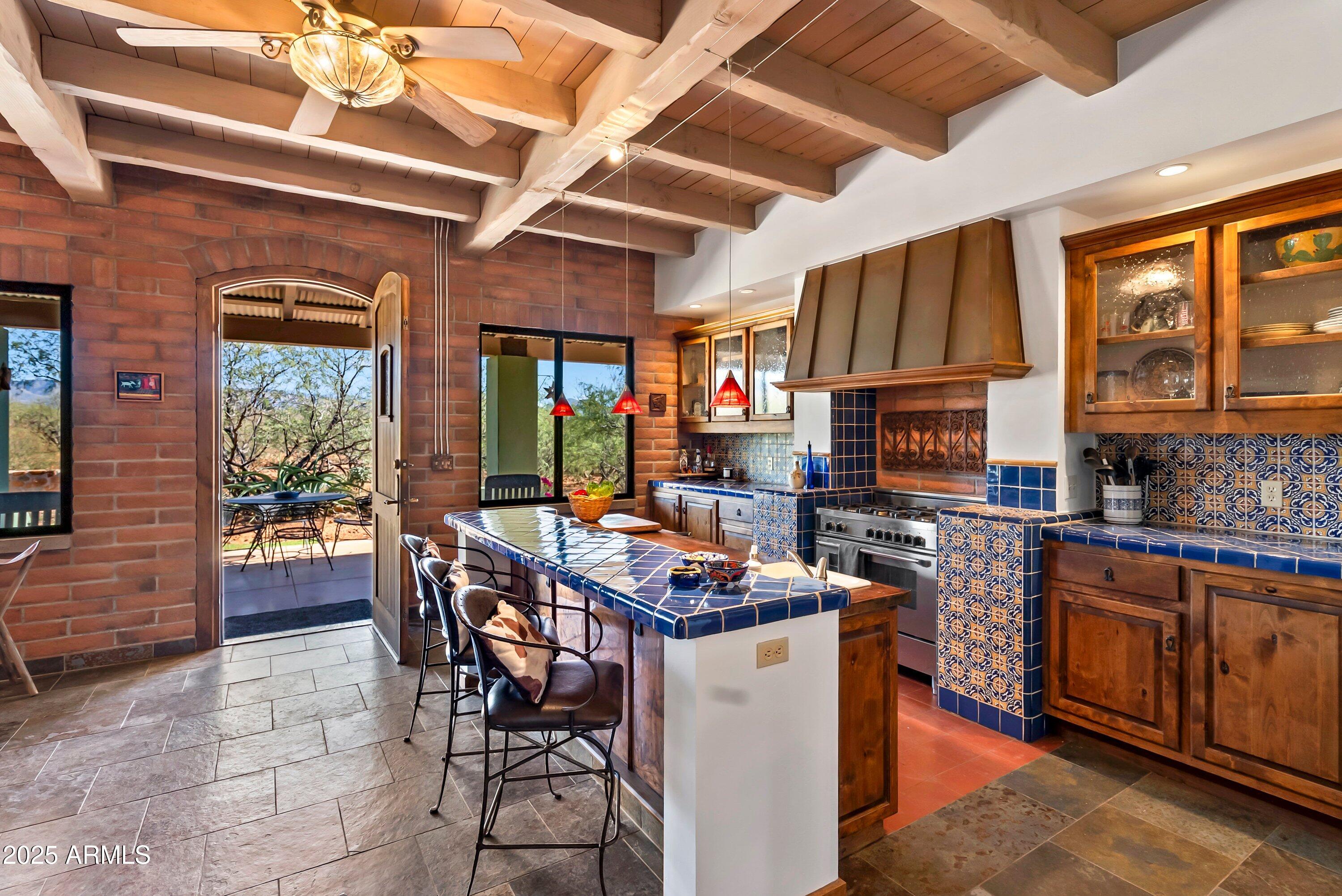 78 Camino Murphy Rio Rico, AZ 85648 - Photo 8 of 51 a room with stainless steel appliances kitchen island granite countertop a stove a sink dishwasher and a dining table with wooden cabinet