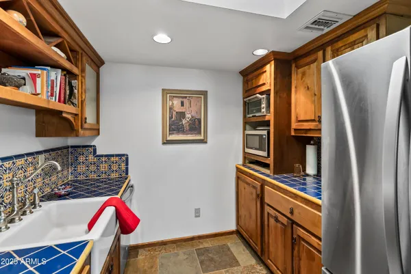 a kitchen with stainless steel appliances granite countertop a refrigerator and a stove